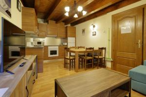 a kitchen with a table and a dining room at Aizkolarienea in Ochagavía