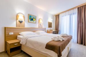 Postel nebo postele na pokoji v ubytování Villa Paradiso 2