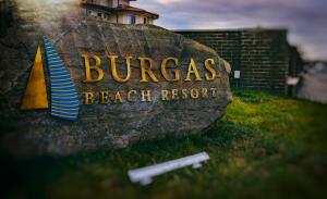 a sign for a beach resort on a rock at Burgas Beach Resort Apartments in Burgas