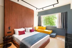 a bedroom with a bed and a window at Colors Hotel Athens in Athens