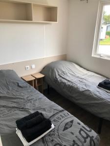 - une chambre avec 2 lits et une fenêtre dans l'établissement Chalet Relax, à Oostkapelle