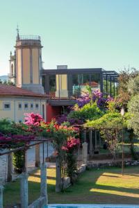 a building with flowers and a building with a tower at Quinta da Malaposta - Boutique Hotel & Eventos in Vila Nova de Cerveira