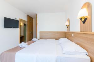 Postel nebo postele na pokoji v ubytování Villa Paradiso 2