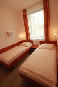 Säng eller sängar i ett rum på Gästehaus Waldeslust
