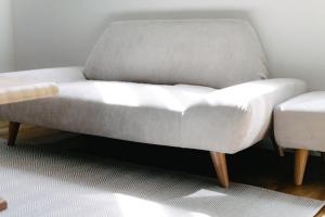 a white couch sitting in a living room at Hanke Sandwich & Inn in Sapporo