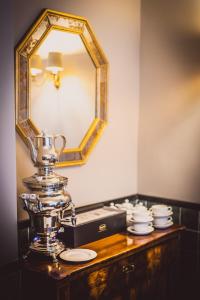 a mirror sitting on top of a table with a tea kettle at HENRI Hotel Wien Siebterbezirk in Vienna