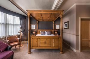 a bedroom with a canopy bed in a room at The Swan Hotel, Stafford, Staffordshire in Stafford