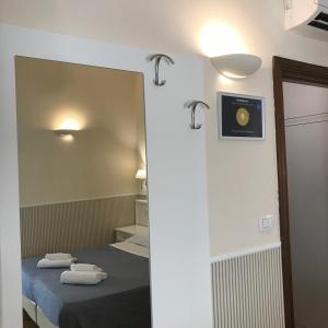 A bed or beds in a room at Relais Duomo Adelaide