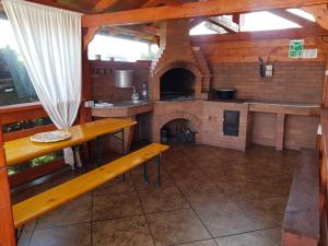 a kitchen with a brick oven with a bench in it at Cabana Corbu in Beclean