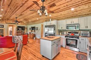 eine große Küche mit Holzdecken und einem Deckenventilator in der Unterkunft Blue Ridge Parkway House with Mountain Scenery! in Glade Valley
