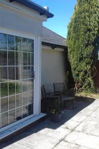 a patio with a sliding glass door and a bench at Edge of Exmoor Garden Flat, dog friendly, sleeps 2 - 4 in East Anstey