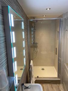 a bathroom with a shower and a sink and a tub at The Wheatsheaf Inn in Onneley