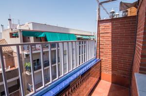 un balcone di un edificio adiacente a un edificio in mattoni di tuGuest Lope de Vega Apartment a Granada
