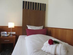 Postel nebo postele na pokoji v ubytování Ringhotel Bundschu