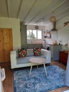 a living room with a couch and a table at Estuary View in Machynlleth