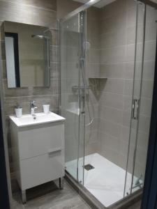 a bathroom with a shower with a sink and a glass shower stall at MONT BLANC HOLIDAYS dans résidence avec Gardien in Sallanches +12 photos