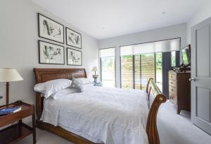 a bedroom with a large bed and a window at Beauvoir Court Stables in Dorchester