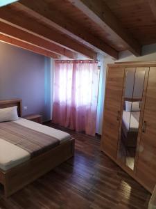 a bedroom with a bed and a cabinet with a window at VILA VANESSIMO in Eforie Sud +55 photos