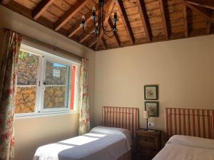 a bedroom with two beds and a window at Villas Las Cercas in El Paso