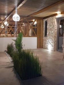 a large patio with a wooden ceiling and a plant at Agorastos Luxury Living in Platamonas