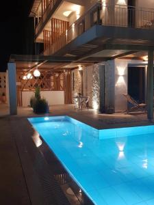 a swimming pool in a house at night at Agorastos Luxury Living in Platamonas