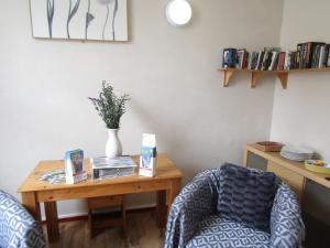 a living room with a table and a chair at Silverstone House in Great Yarmouth