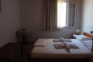 a bedroom with a bed with towels on it at Koula's Place in Elafonisos
