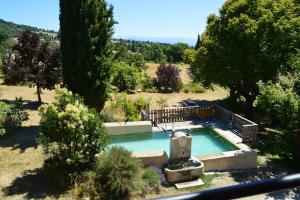 a small swimming pool in a field with trees at La Bastide Du Claus - Vitaverde in Cruis