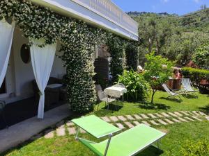 a patio with a table and chairs in a yard at Il Profumo di Capri in Massa Lubrense