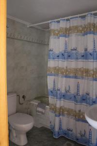 a bathroom with a toilet and a shower curtain at Koula's Place in Elafonisos
