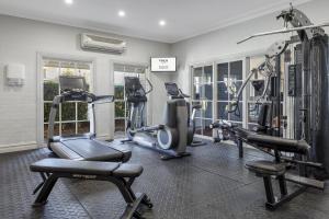 a gym with several treadmills and exercise machines at voco™ Kirkton Park Hunter Valley, an IHG Hotel in Pokolbin