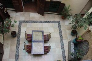 an overhead view of a table and chairs on a tile floor at Dar Aida in Rabat
