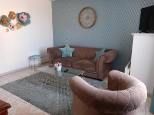 a living room with a couch and a coffee table at la maison de maelys in Courcelles-lès-Gisors