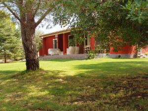 a red house with a tree in the yard at Villa Franca in Pula