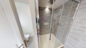 a shower with a glass door in a bathroom at Le Quai KOCH in Strasbourg +7 photos