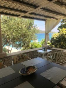 a table with a bowl of food on top of a patio at Apartments Tomović in Korčula