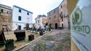 an empty street in an old city with buildings at Ottocento Guest House in Alghero