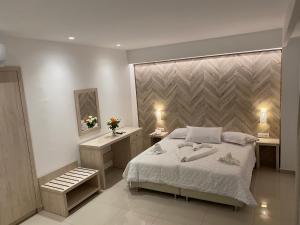 Posteľ alebo postele v izbe v ubytovaní AGRELLI Hotel & Suites
