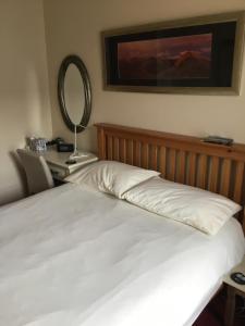 
a bedroom with a bed and a lamp at Bed and Breakfast at 4 in Thurso
