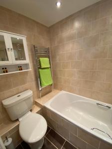 a bathroom with a white toilet and a tub at The Hideaway in Northallerton