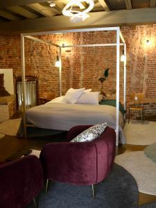 a bedroom with a large bed and two chairs at De Pelsertoren in Zwolle