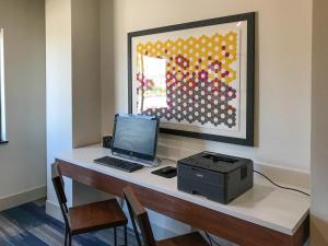 a desk with a laptop and a printer on it at Holiday Inn Express & Suites Lubbock West, an IHG Hotel in Lubbock
