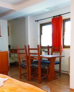 a dining room with a wooden table and chairs at Guesthouse Kohári in Egerszalók