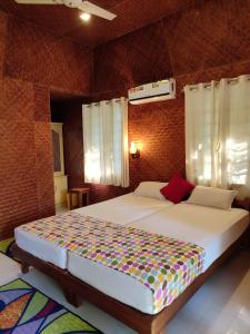 a bedroom with a large bed in a room at Coconut Garden in Cherai Beach