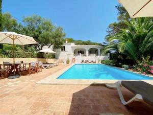 a villa with a swimming pool and a house at Boscimar in Sant Lluis