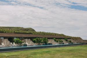 a rendering of a building with chairs and trees at Santa Barbara Eco-Beach Resort in Ribeira Grande
