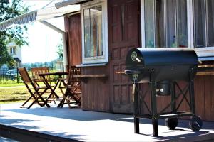 a barbecue grill on the porch of a house at Domek pod Lipą in Narol
