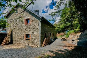 a stone house on the side of a road at Le Rocher Du Lac in Houffalize +23 photos