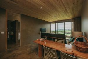 a dining room with a wooden table and chairs at Santa Barbara Eco-Beach Resort in Ribeira Grande