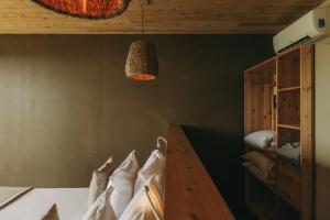 a bedroom with a bed with a wooden table and a lamp at Santa Barbara Eco-Beach Resort in Ribeira Grande